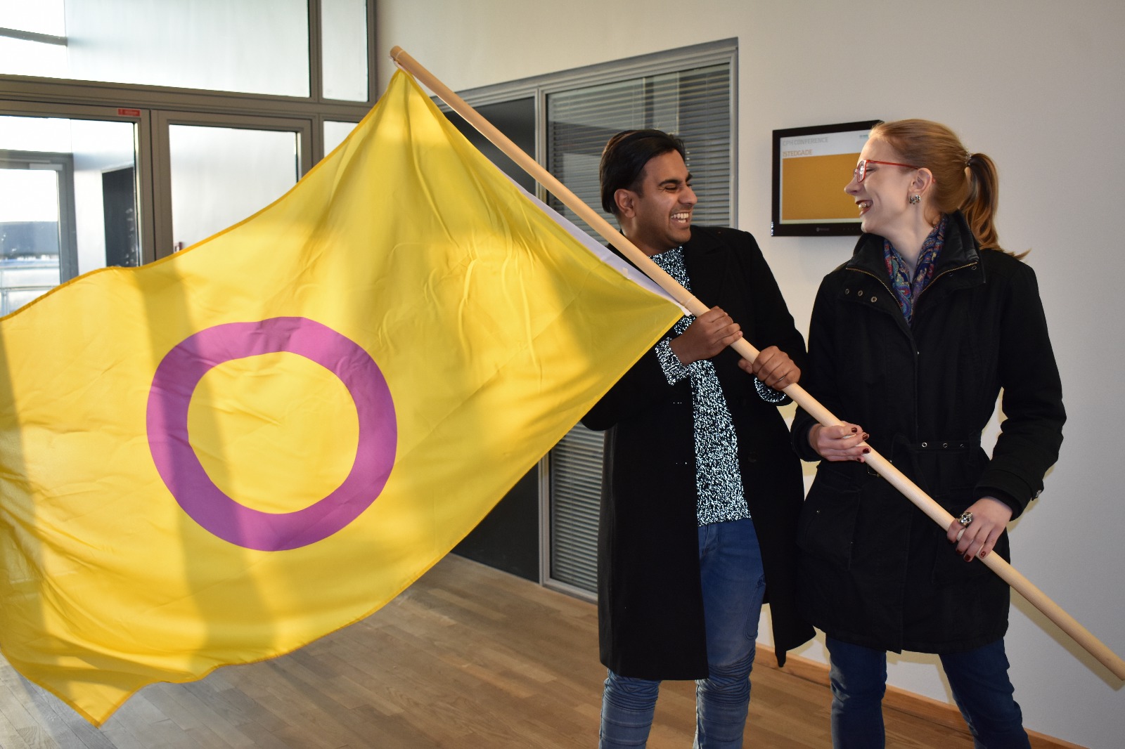 Anick and fellow intersex activist and interACT Youth member Irene waving an intersex flag at the Oii Europe 2018 Community Event in Copenhagen.
