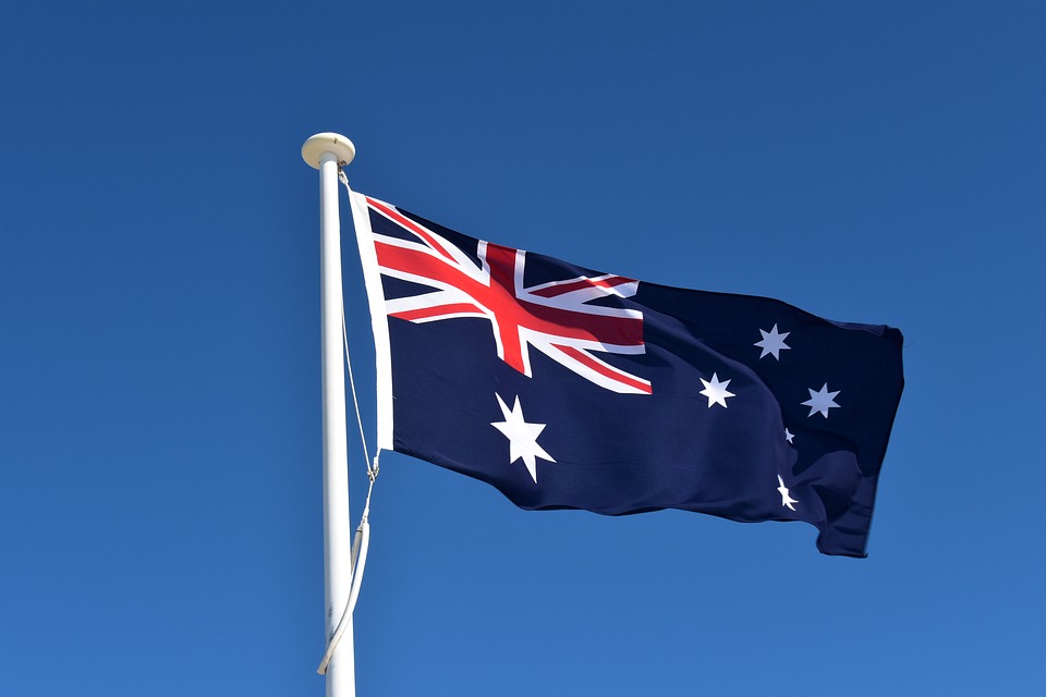 Australian flag against a simple blue sky