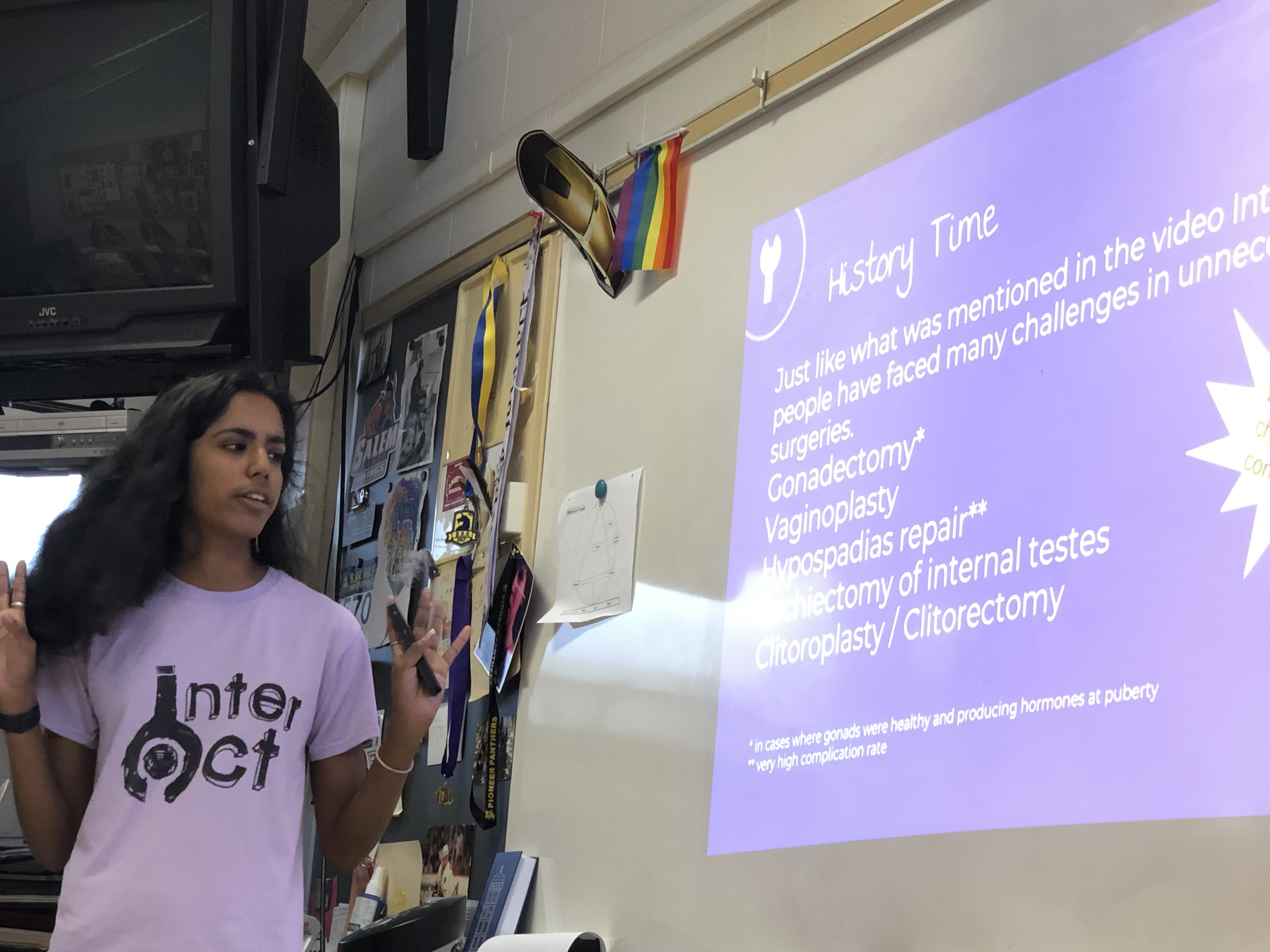 interACT Youth Member Banti stands in front of a PowerPoint presentation on intersex issues, given at a GLSEN conference in Massachusetts.
