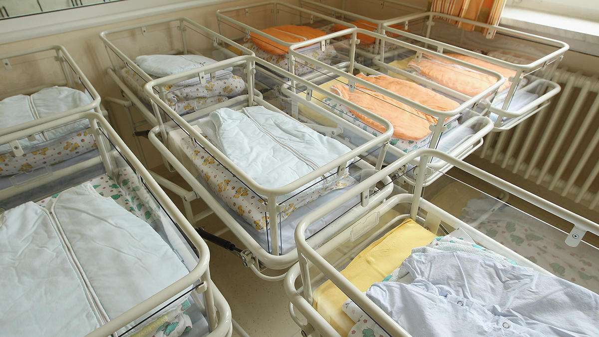 Empty cribs in a hospital maternity ward