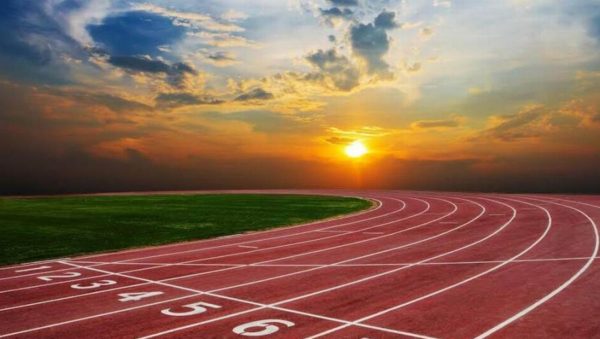 Empty lanes on an outdoor track at sunset