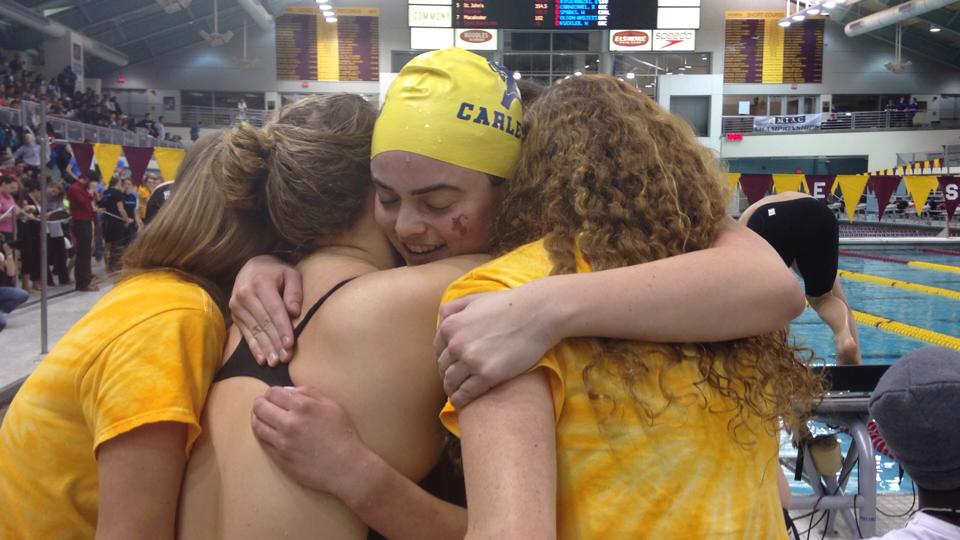 Sam hugs fellow swimmers